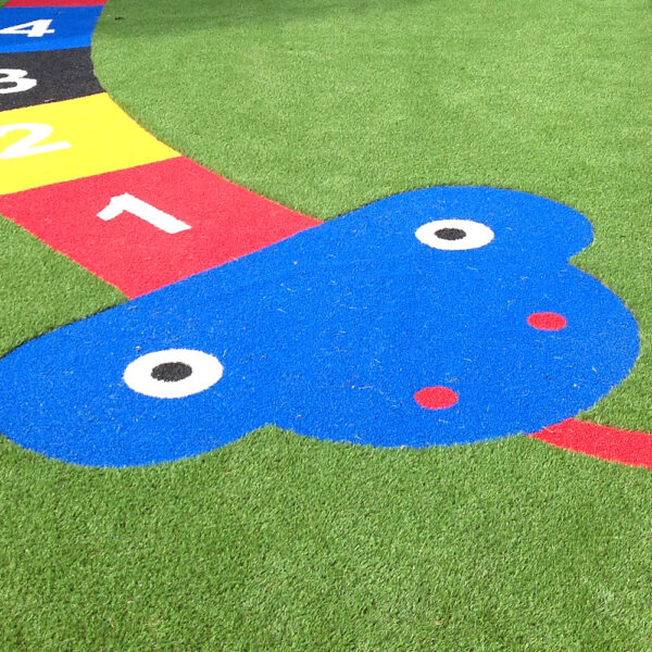 Lazylawn artificial grass being used for a snakes & ladders game in a playground